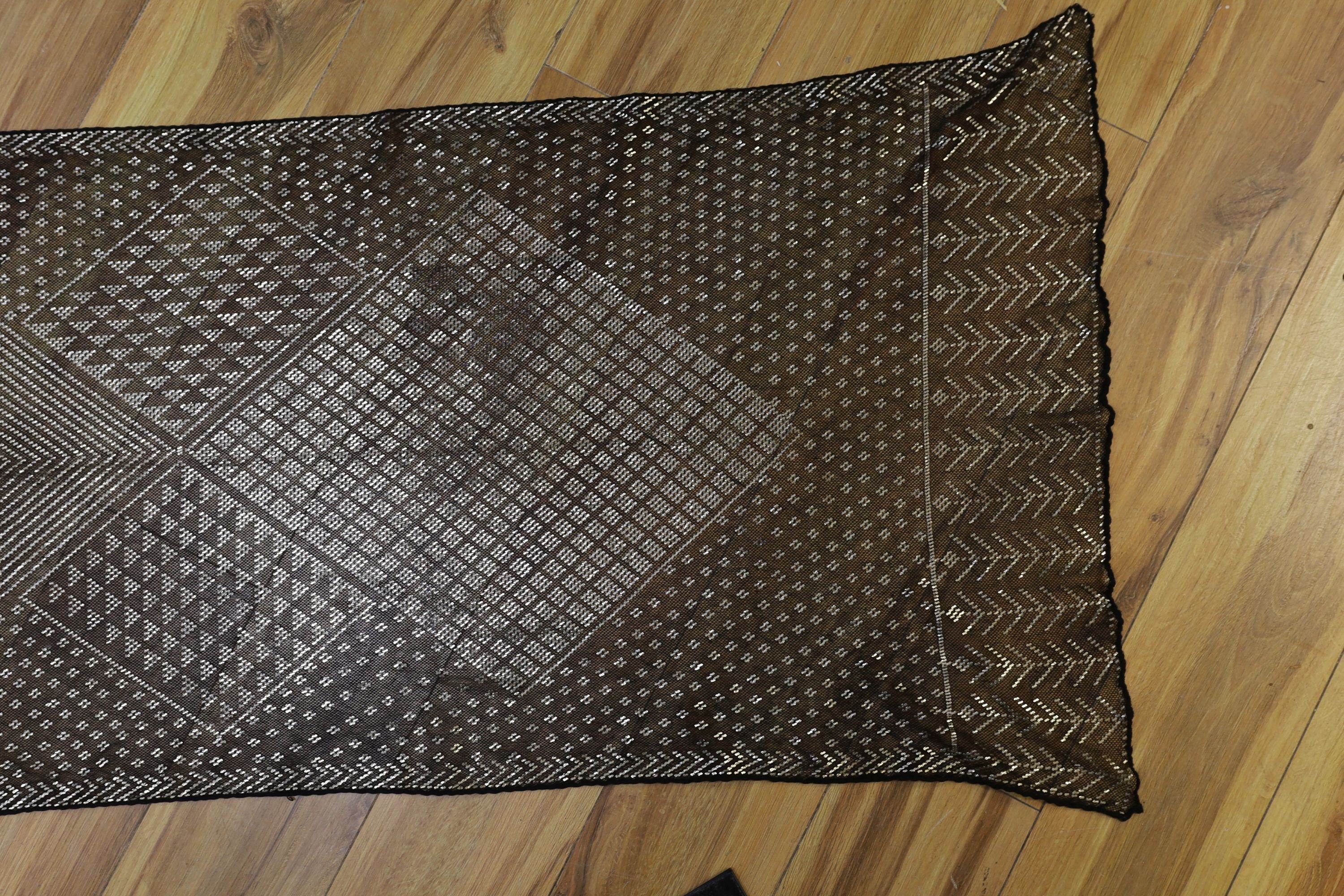 A dress made from a metal and black net Egyptian shawl; a similar shawl and a piece of shawl